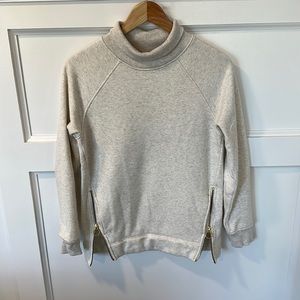 Athleta Cream Sweatshirt with gold zippers on sides. Size XXS.